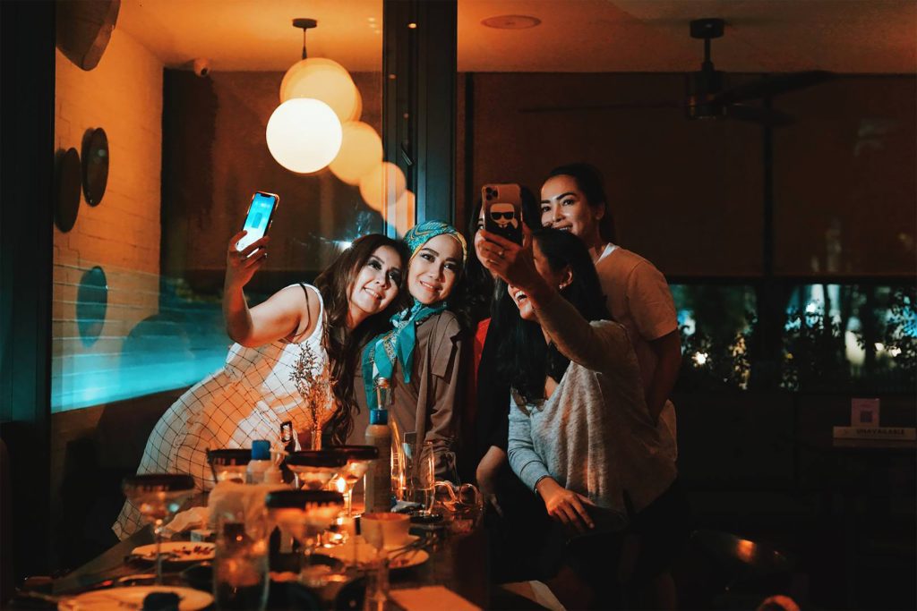 friends taking a selfie at dinner
