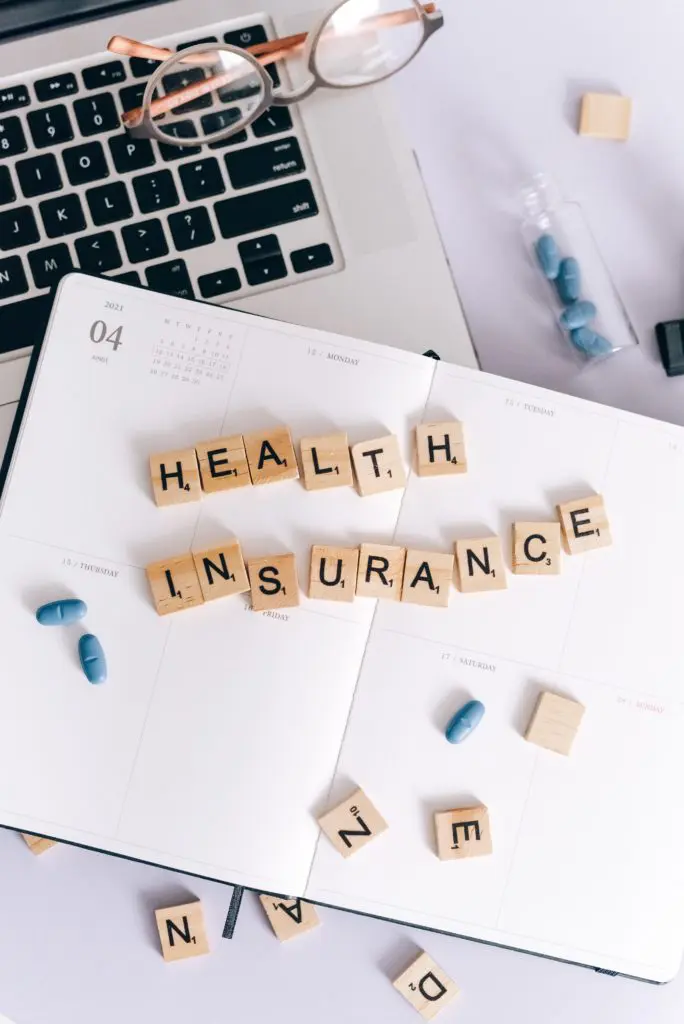 scrabble pieces spelling out health insurance