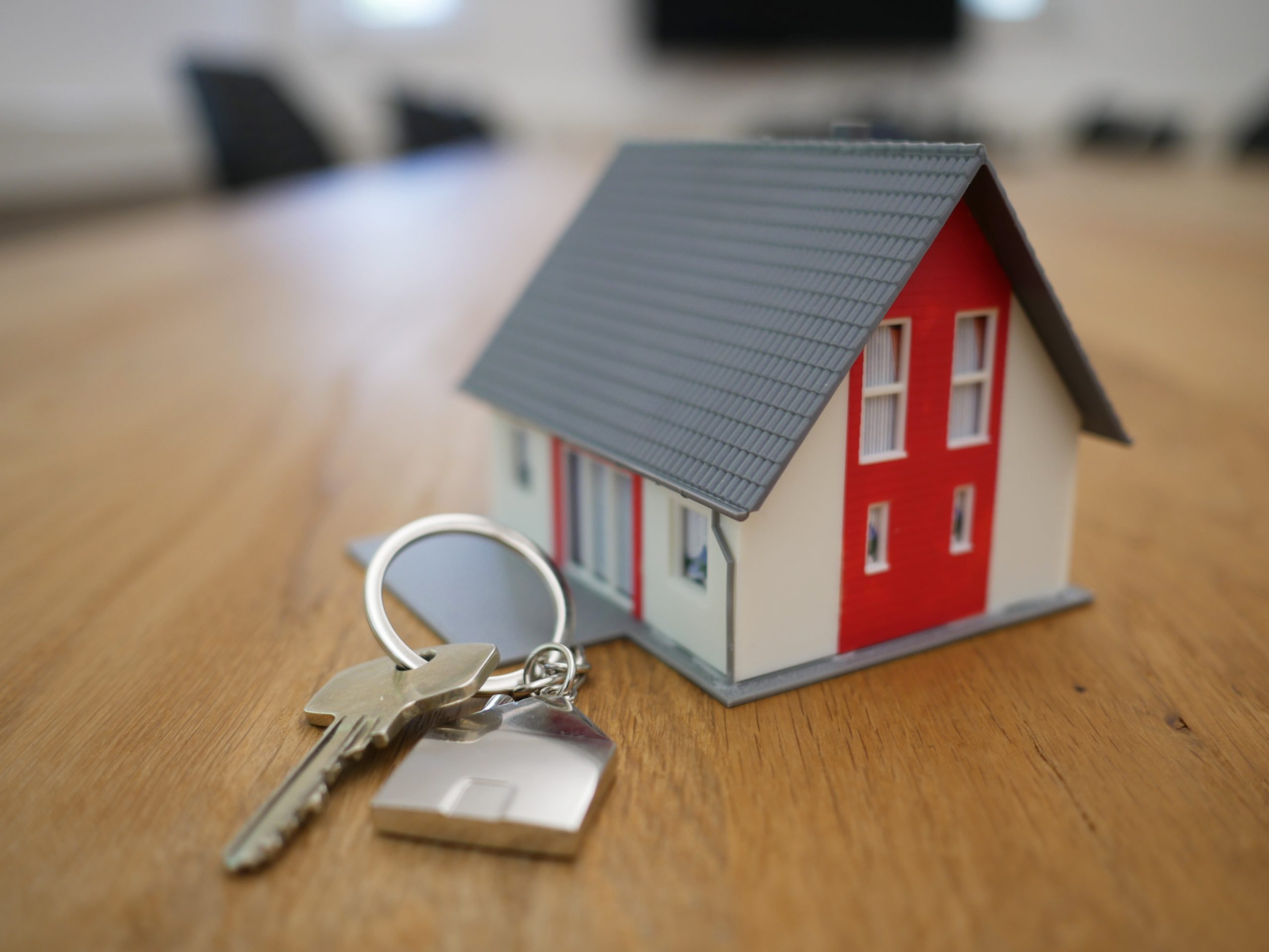small red model house with keys