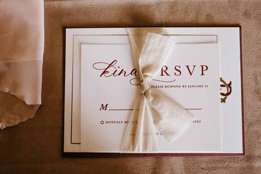 RSVP card in wedding invite with red font