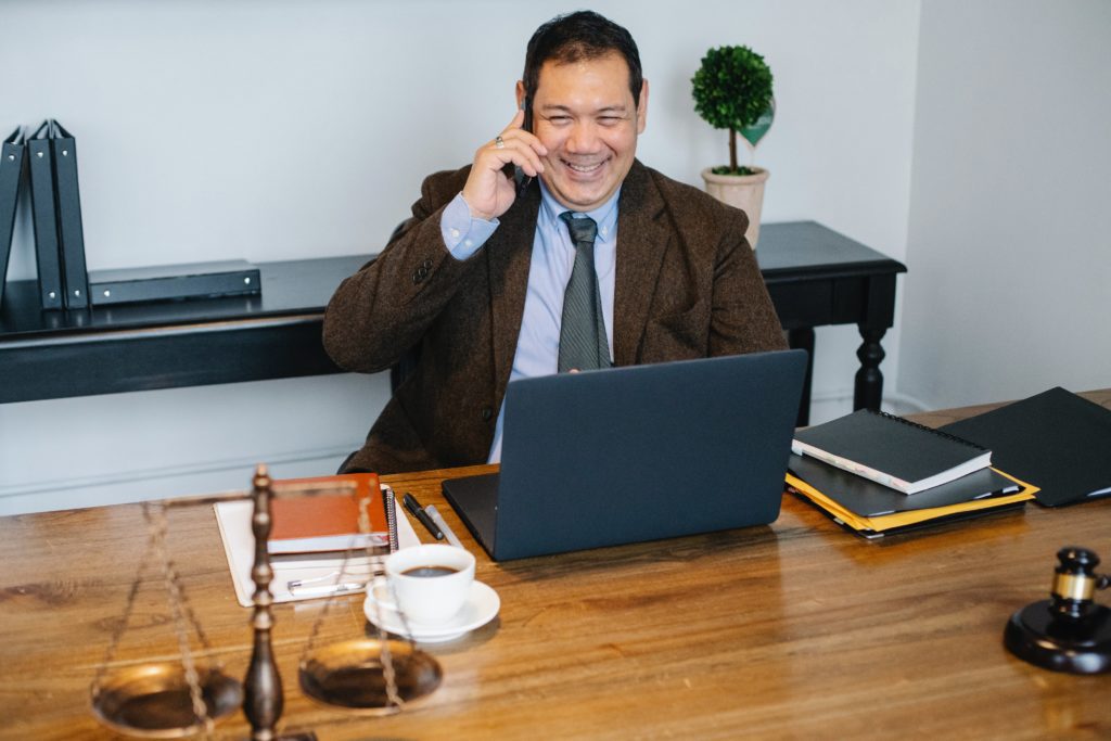 happy lawyer on the phone in his office