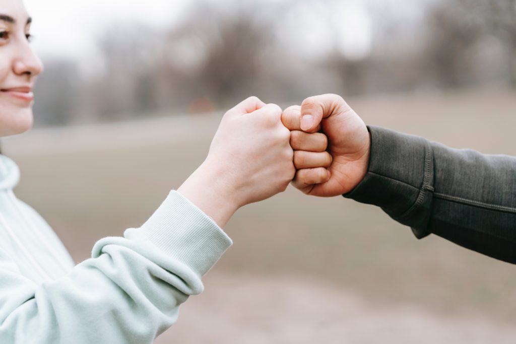 couple giving high fives in the form of help Communicating With Your Partner About Prenup Anxiety