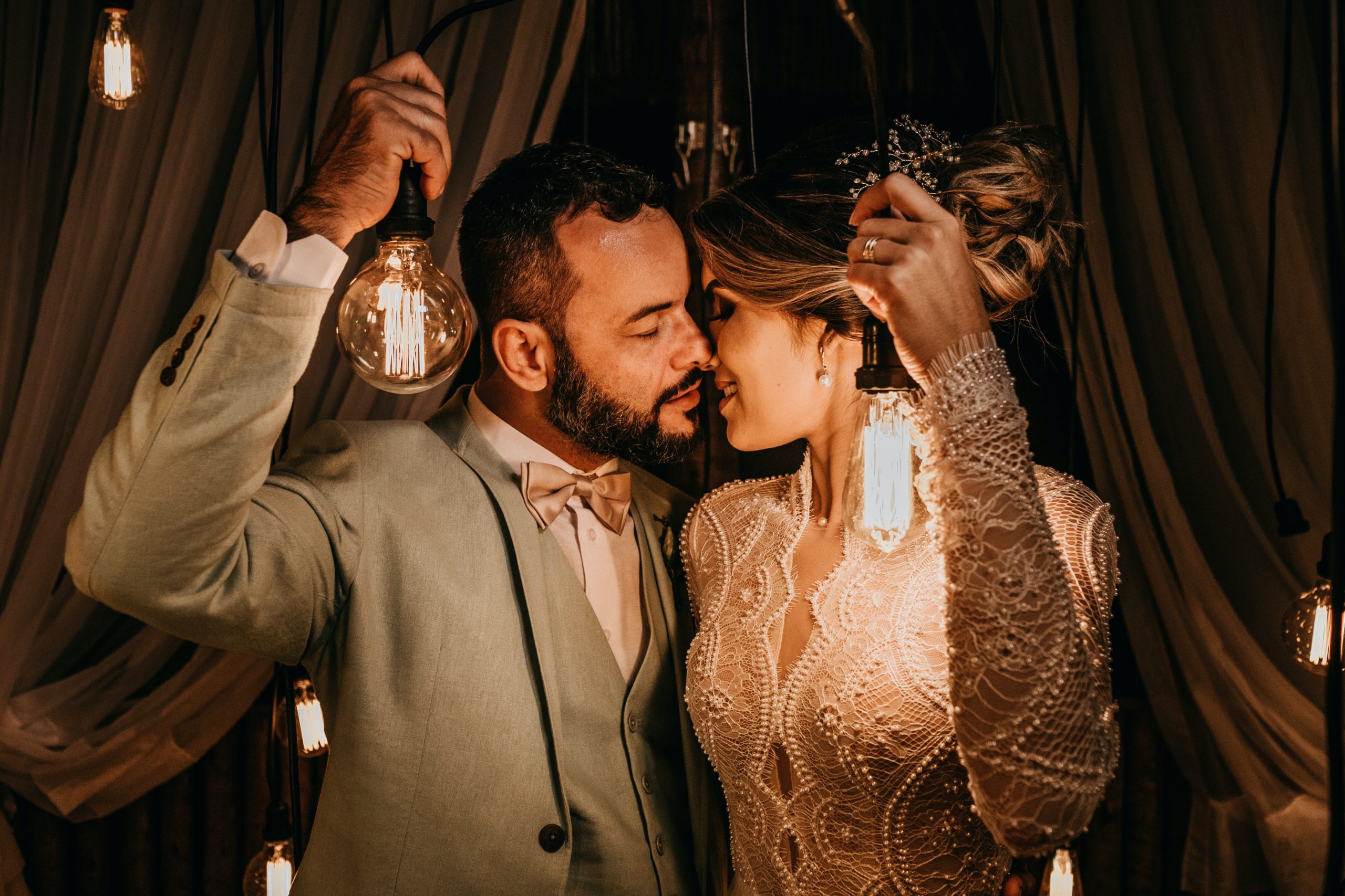 couple holding light bulbs adding Personal Style Into their Wedding