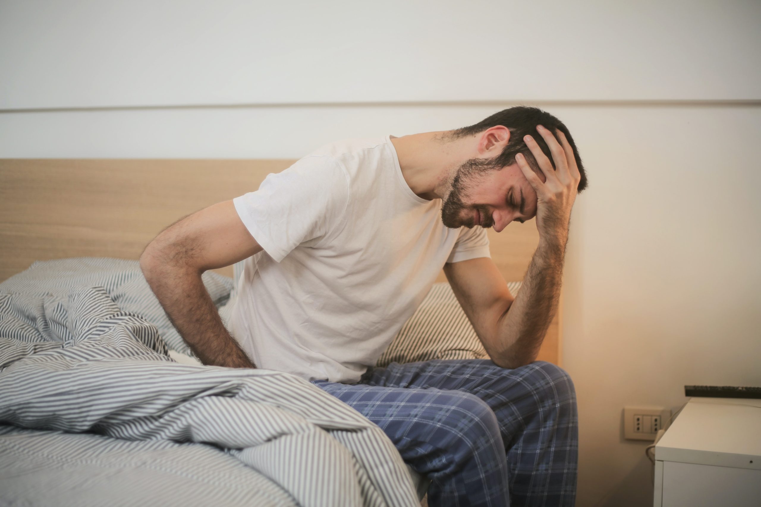 man in bed with anxiety but Prenup Can Reduce Marriage Anxiety