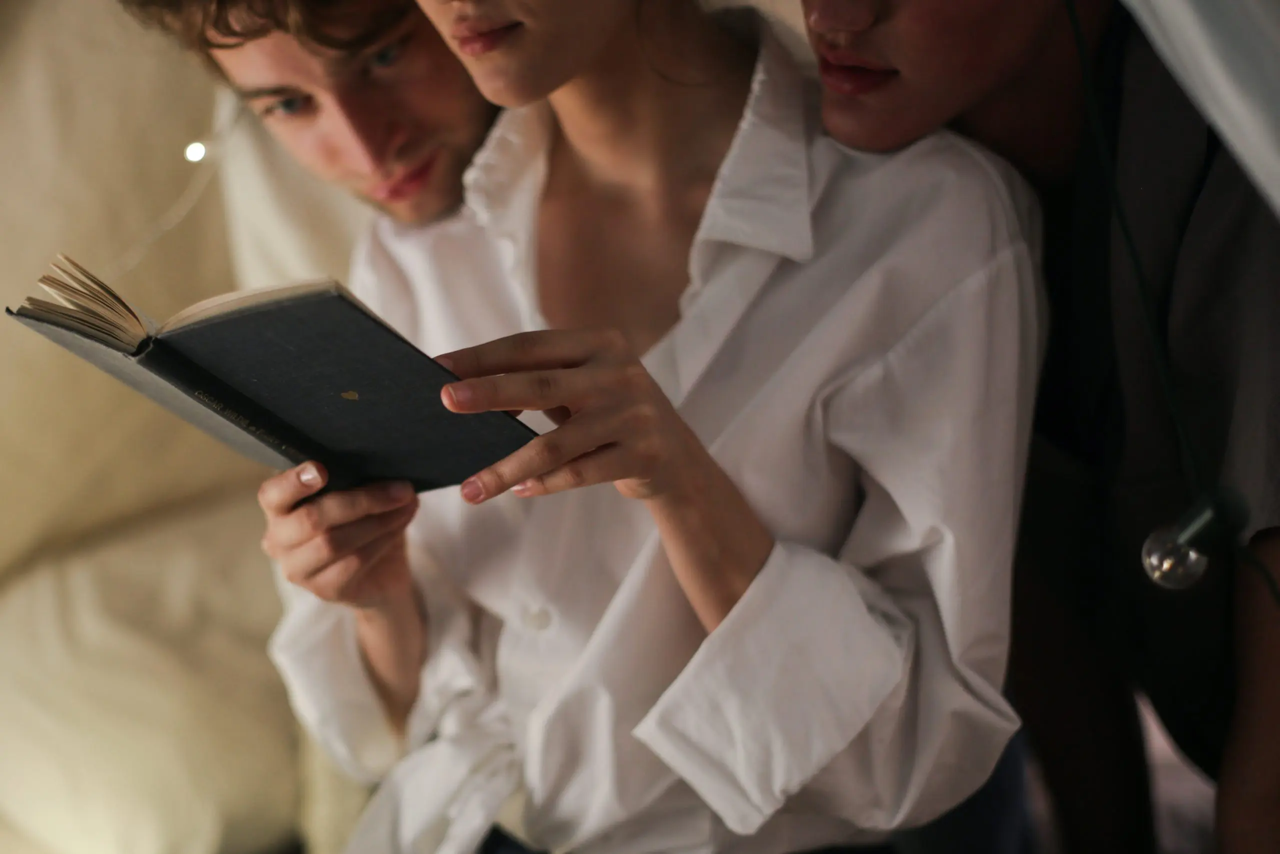 two guys and one woman reading an agenda Navigating Non-Monogamy