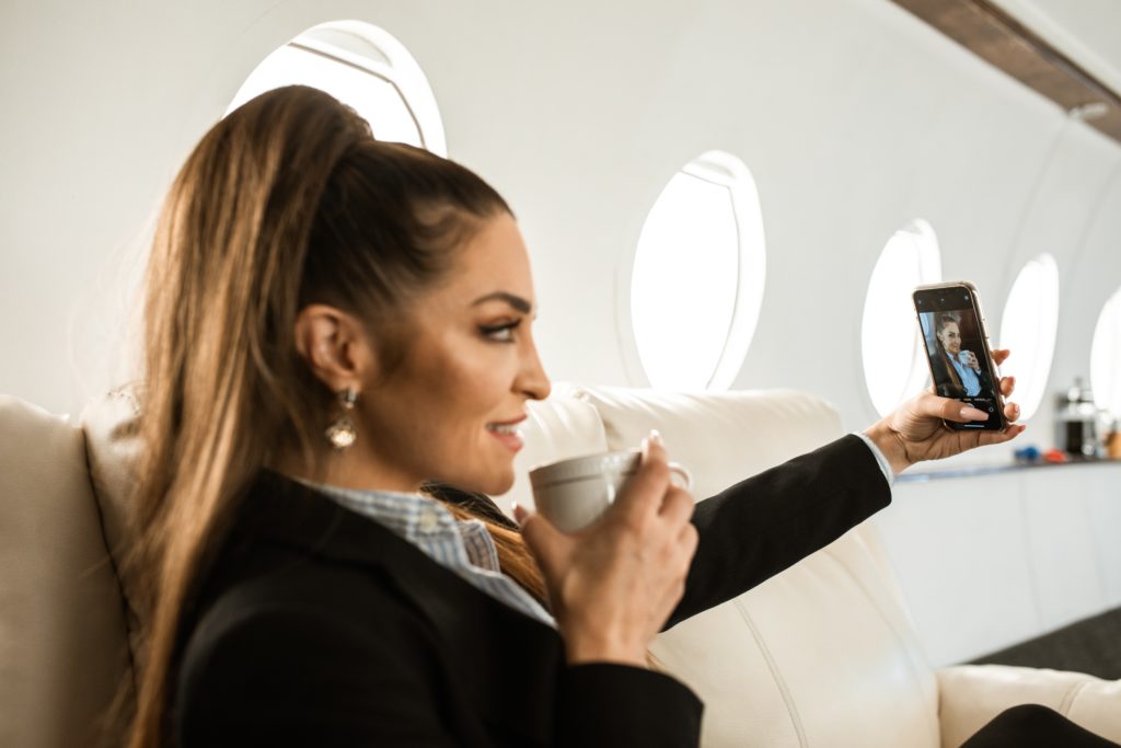 woman taking selfie in private plane What Goes Into A Millionaire’s Prenup?
