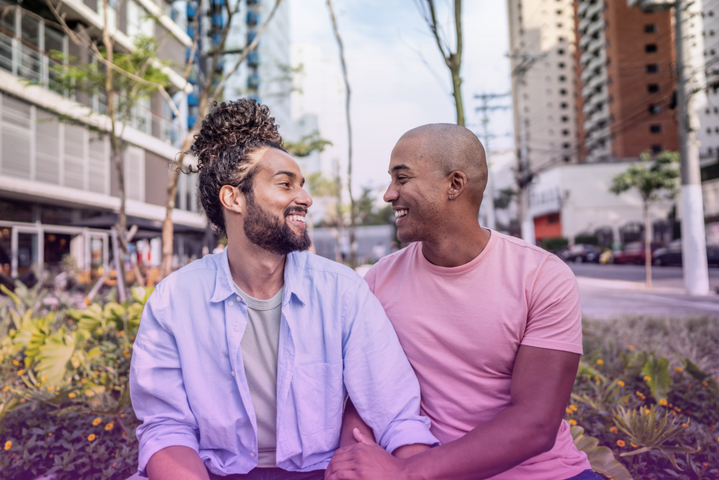 Couple laughing and holding hands in a park