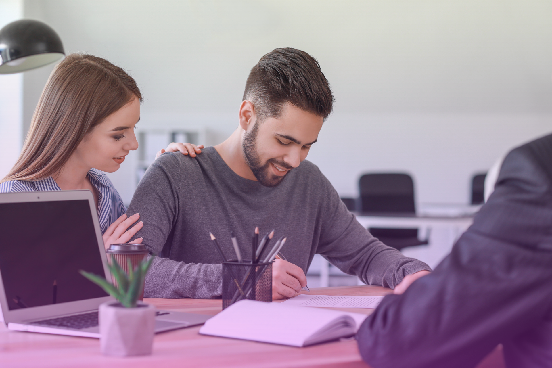 Couple sitting at a table reviewing financial documents together