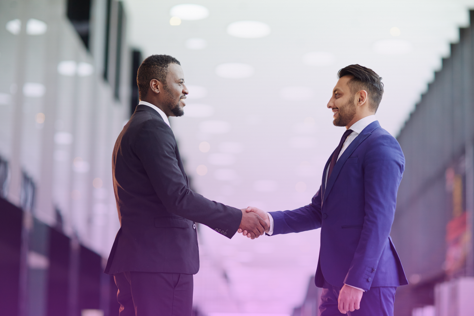 A man and woman shaking hands after reaching an agreement.