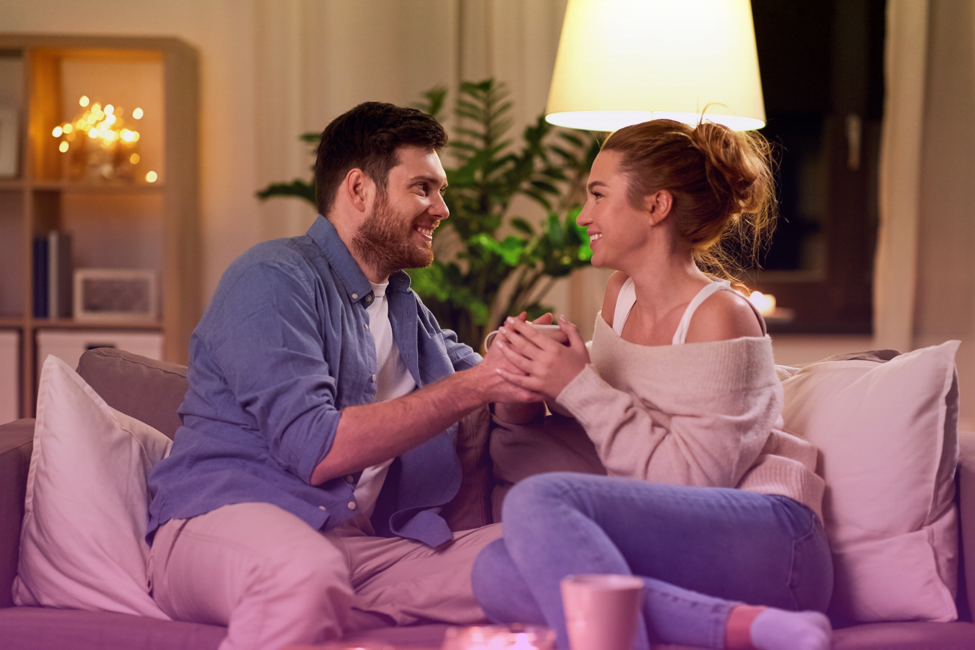 Two partners talk openly and laughingly, building communication and trust in their relationship.