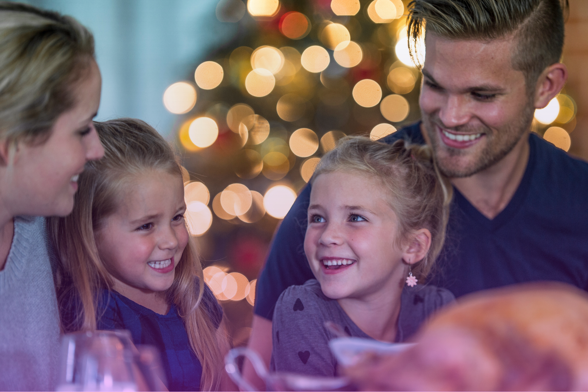 Family-Gathered-Around-Table Family sitting around a table discussing legal documents, symbolizing estate planning conversations.