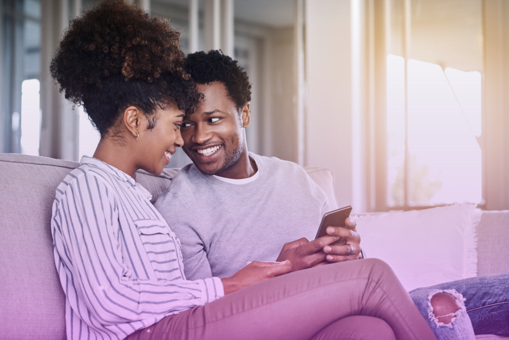 Two hands holding wedding rings, with open palms facing each other.