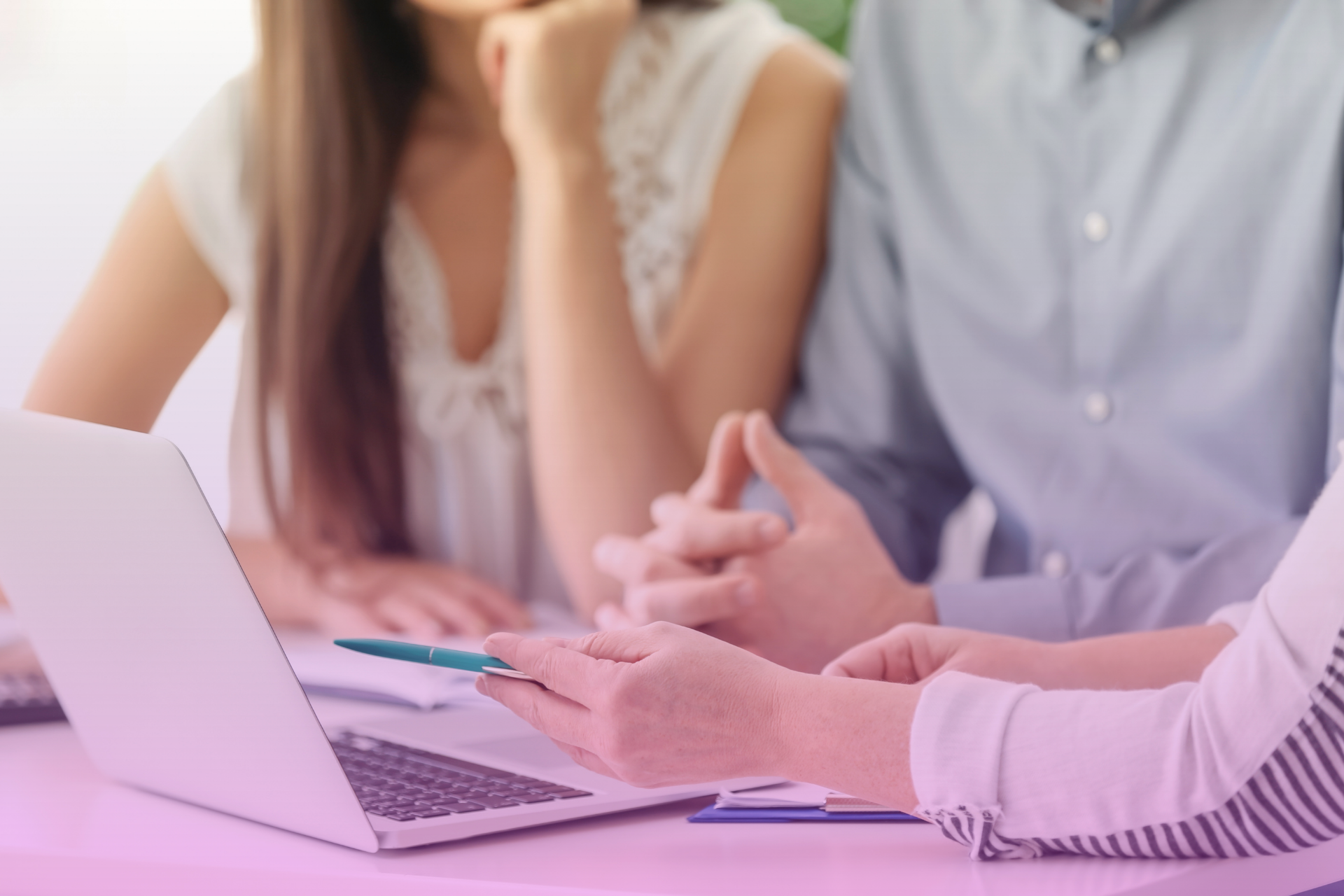 A loving couple sits at a table reviewing financial documents together.