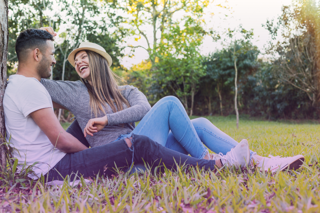 A woman placing a comforting hand on her stressed-looking partner's shoulder, depicting support in a relationship.