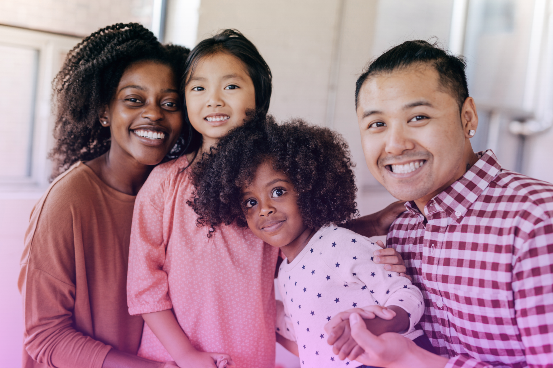 A happy blended family laughing and playing together.