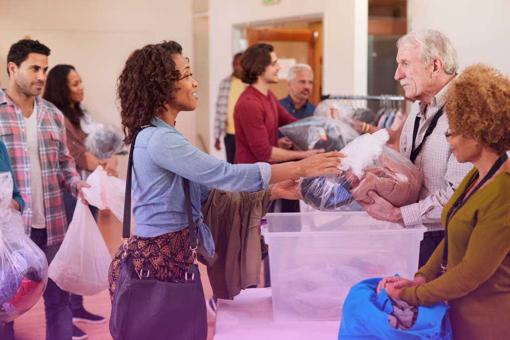 A husband and wife happily donate money to a charity volunteer.