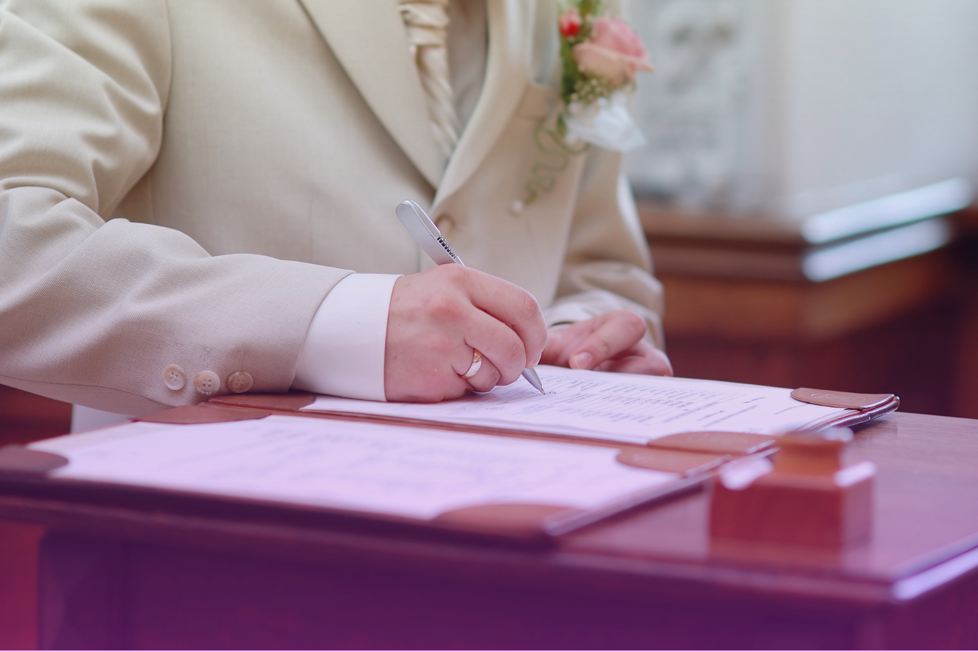 Groom filling out a Texas marriage license application form at a desk.
