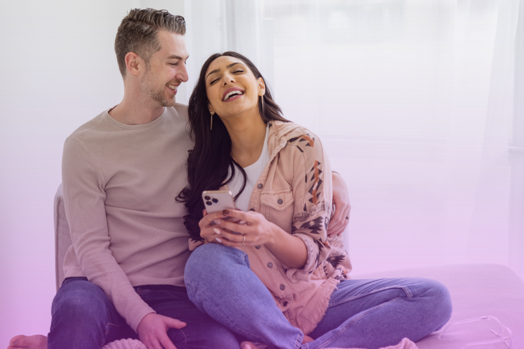 A happy couple laughing together, signifying a strong and joyful relationship.