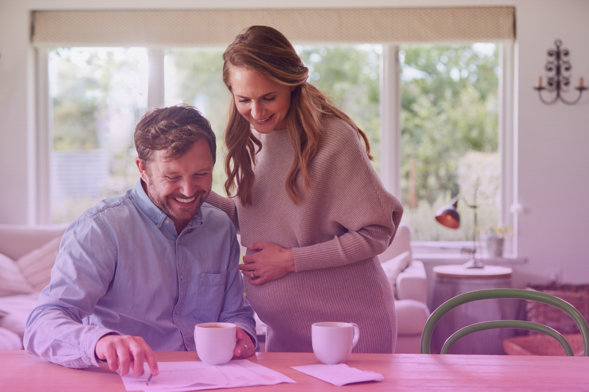 A happy couple reviewing a document together, representing the collaborative process of creating a prenup.