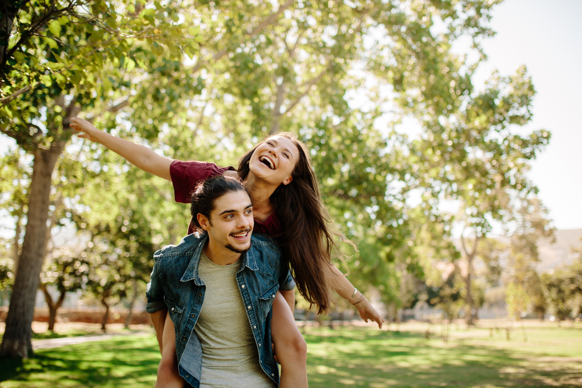 happy couple playing on a sunny day in an Iowa park
