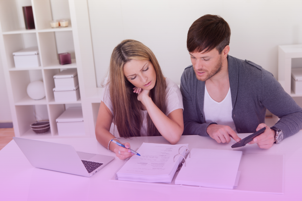 A couple reviewing financial documents together, highlighting financial planning.