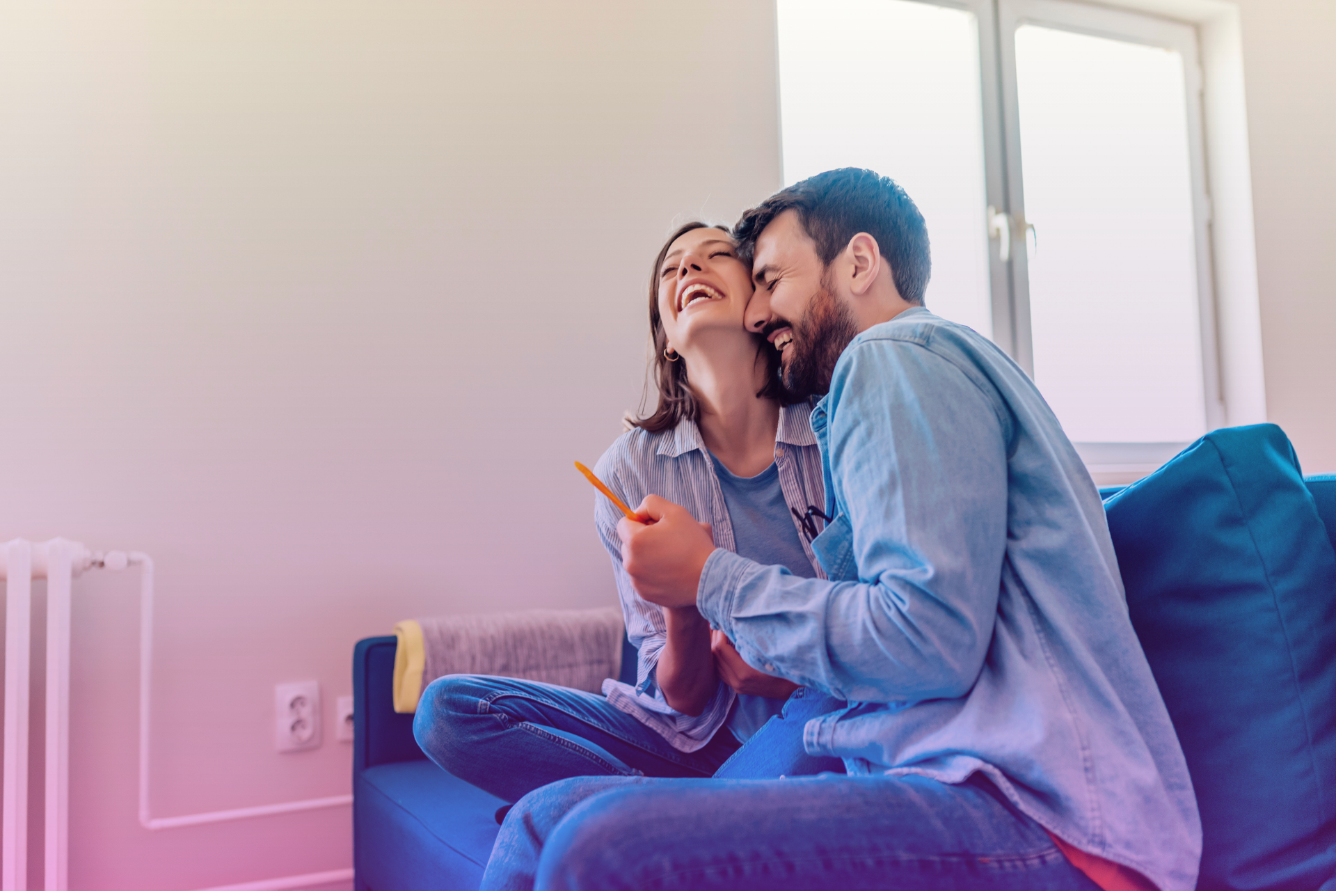 joyful couple embracing after receiving a positive pregnancy test following IVF treatment.