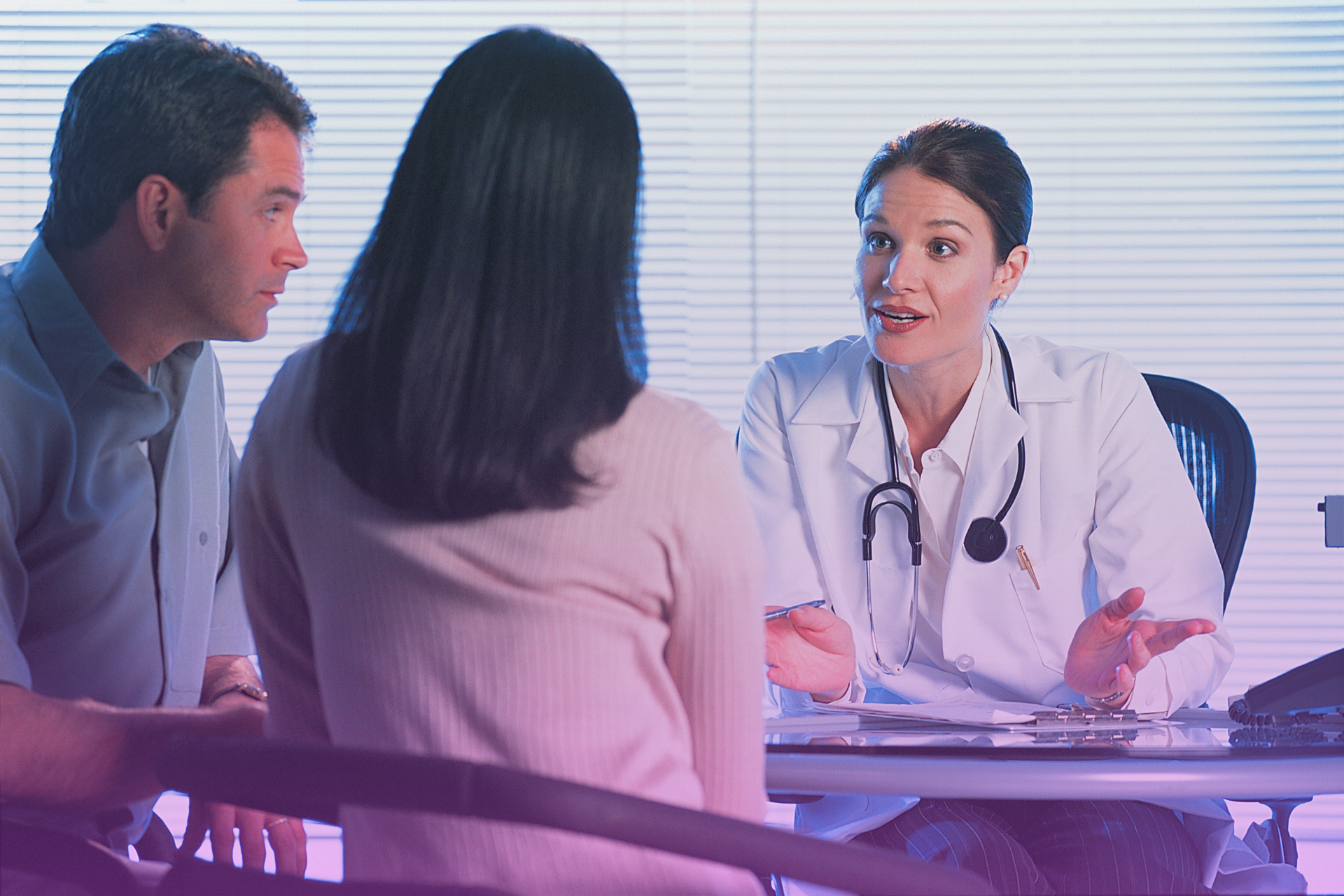 ivf-consultation-couple A couple consults with a doctor about In Vitro Fertilization (IVF) procedures.