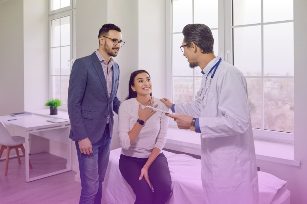A photo of a couple consulting with a doctor about IVF procedures in a medical setting.