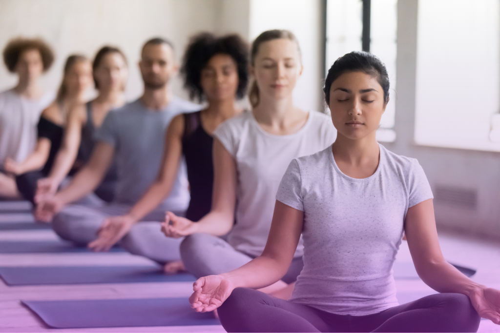 A serene woman meditating in a calm setting, practicing mindfulness to manage stress and anxiety during IVF.