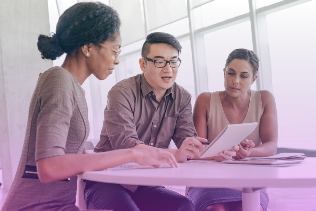 A lawyer discussing a prenuptial agreement with a couple in a professional setting.