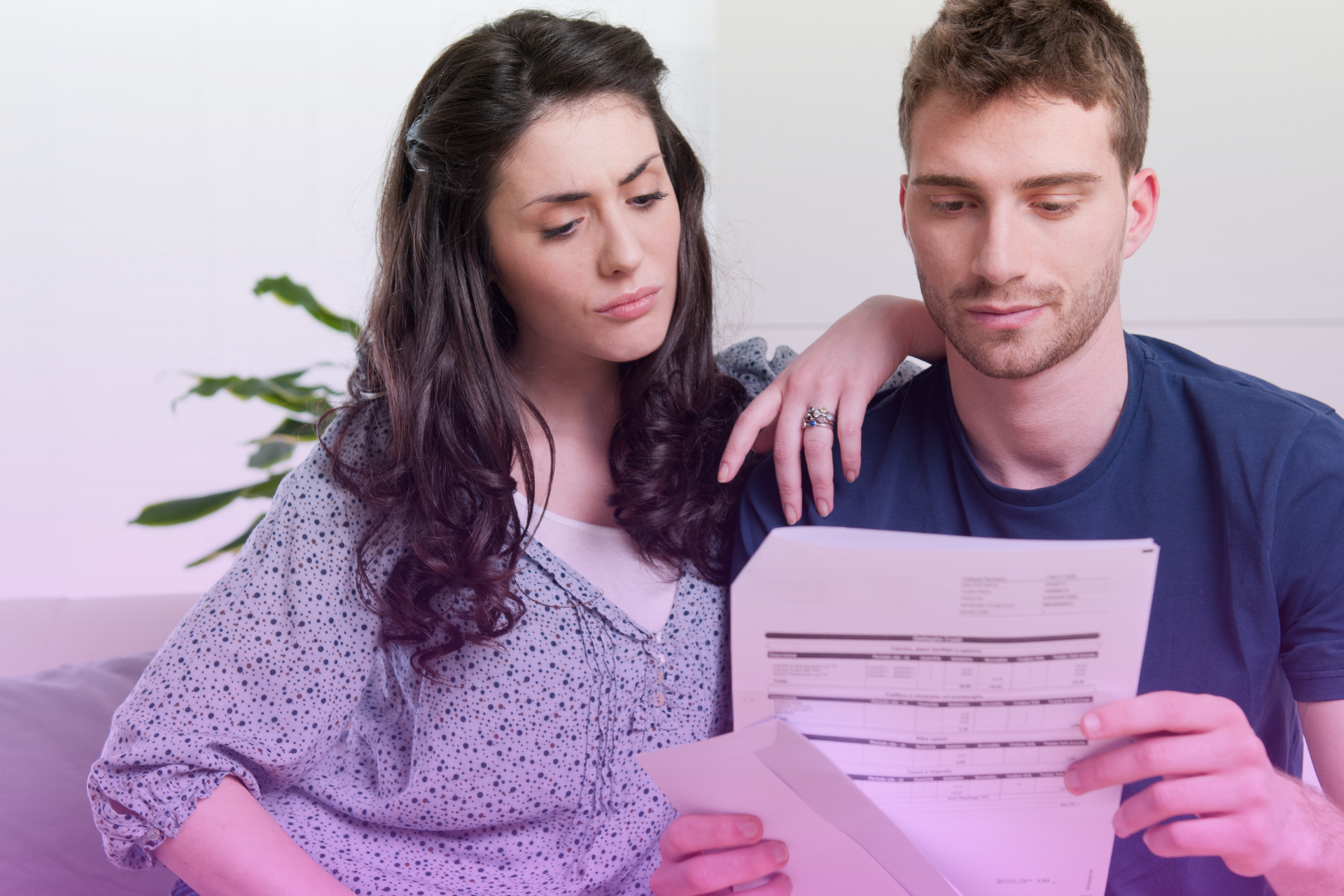 prenup-financial-planning Couple reviewing financial documents with a lawyer holding a prenuptial agreement.