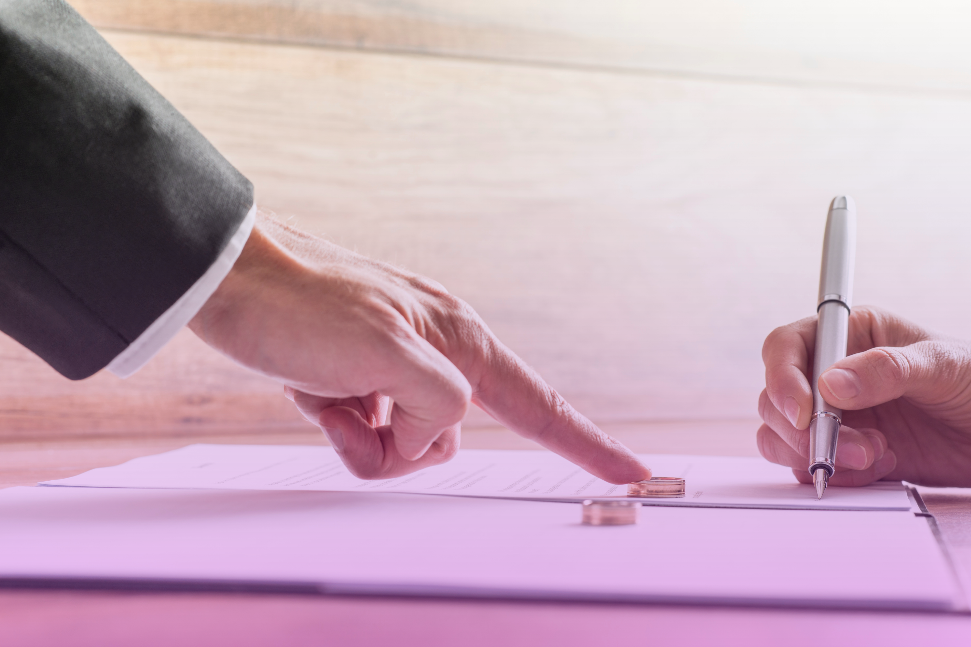 Couple reviewing a prenuptial agreement document with a serious expression.