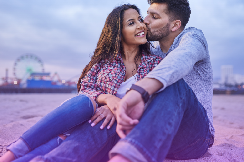 A California couple reviewing financial documents together, focused and engaged.
