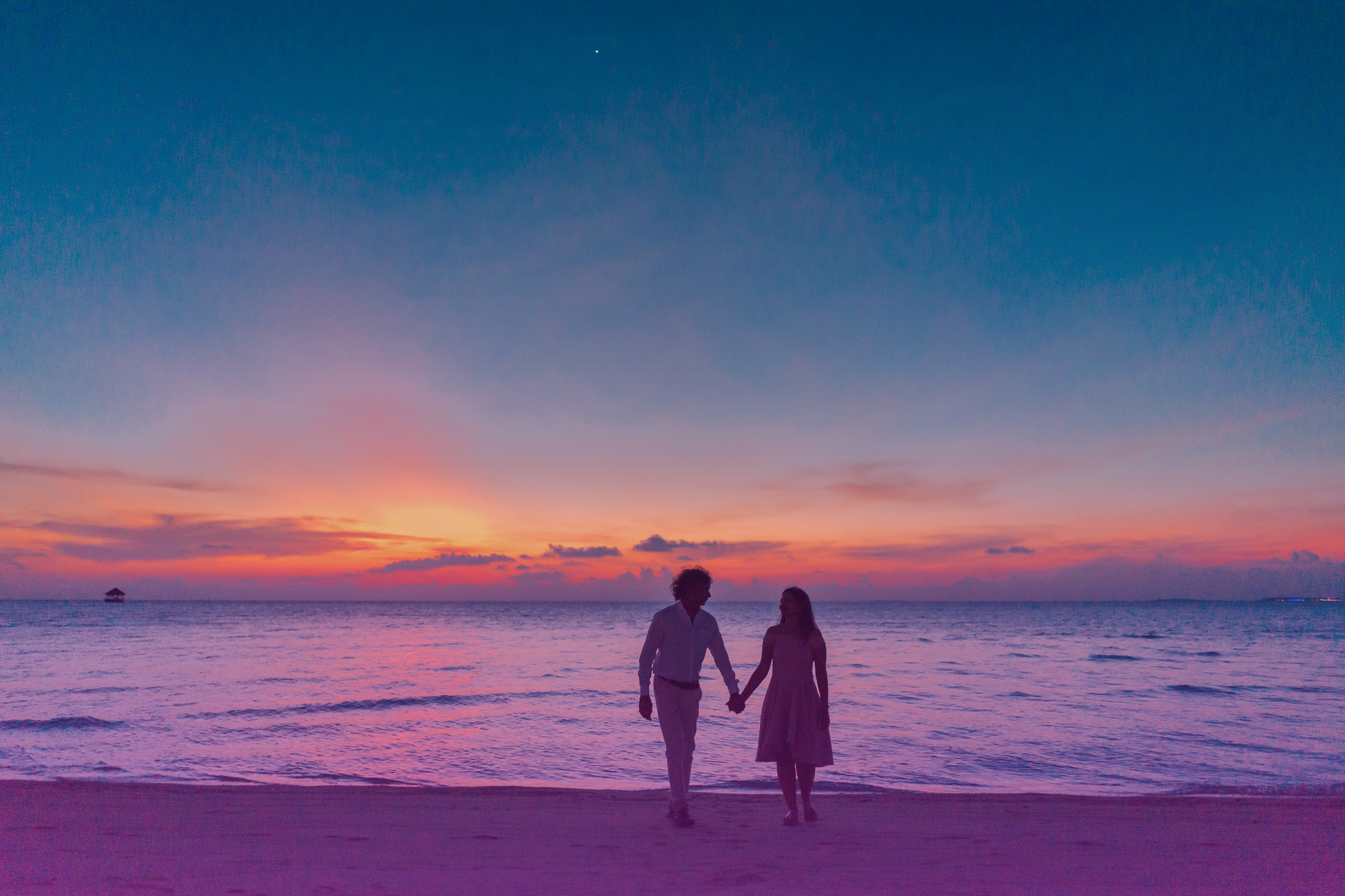 ocean-county-modern-couple A smiling couple holding hands in a park, symbolizing a secure future built with a prenup.