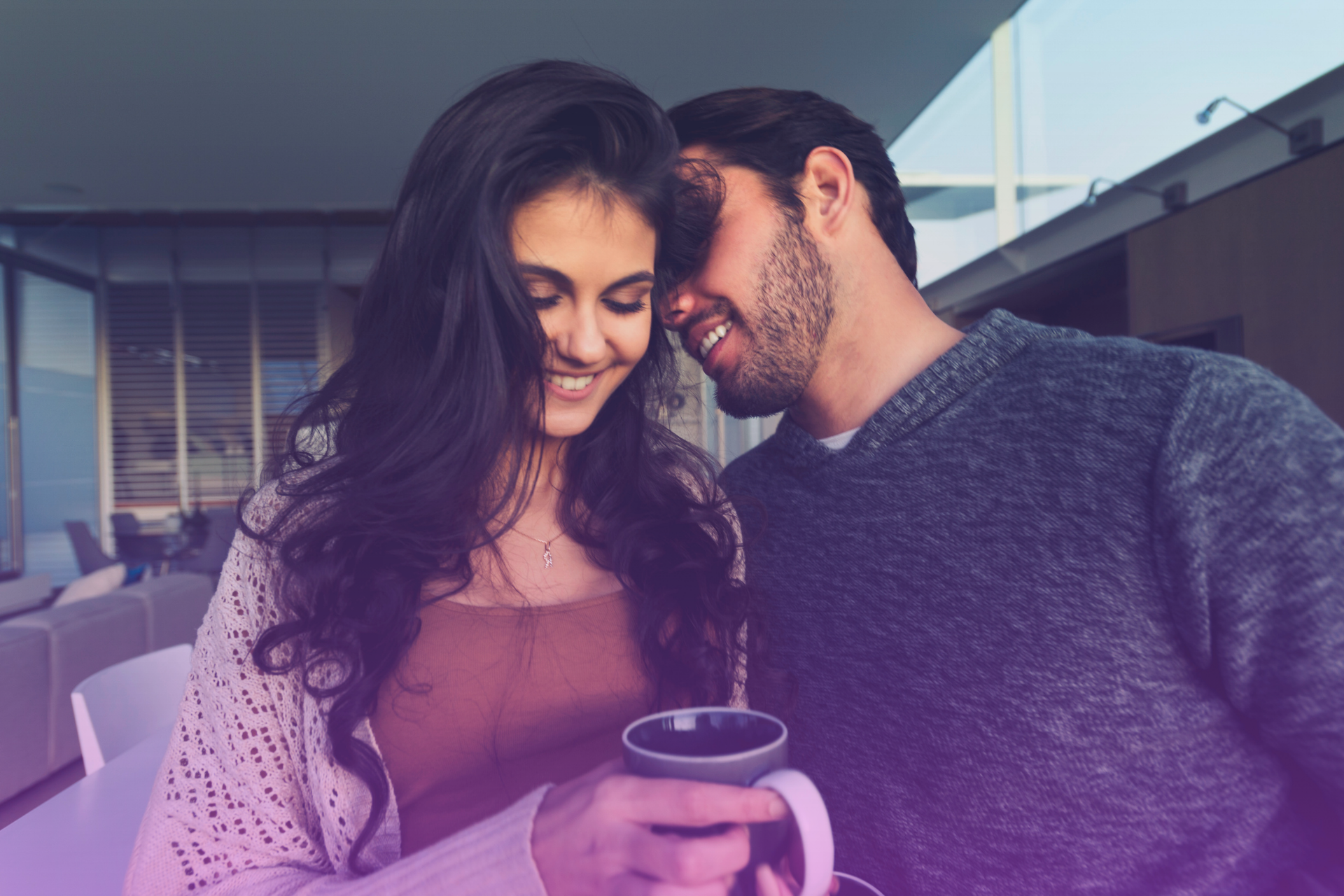 Love and Laughter Building a Stronger Future Together A joyful couple sharing a laugh and a sweet cheek kiss, symbolizing their commitment and connection—a perfect moment to discuss postnuptial agreements.
