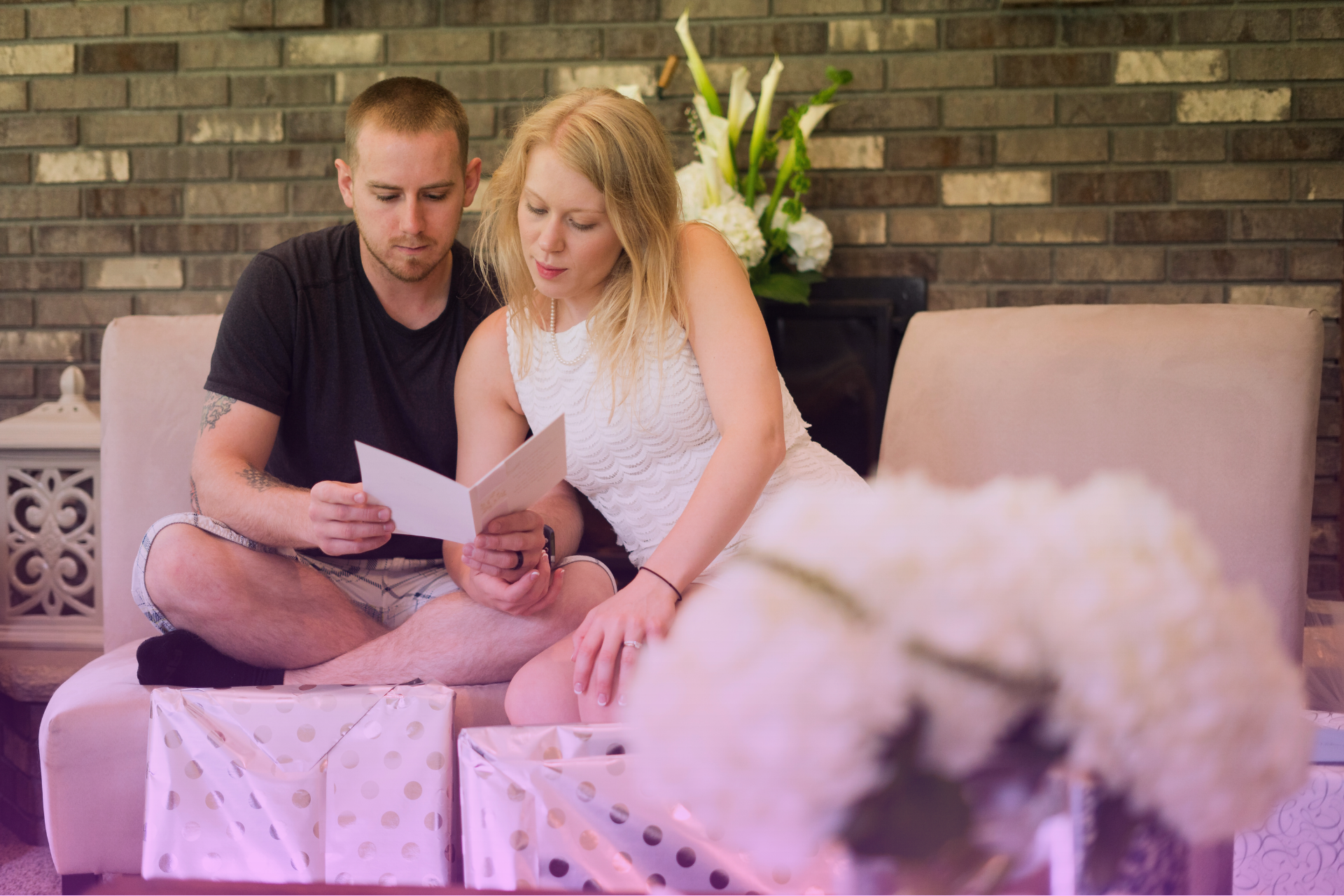 A smiling couple opening their wedding gifts together, surrounded by beautifully wrapped presents and heartfelt moments of gratitude.