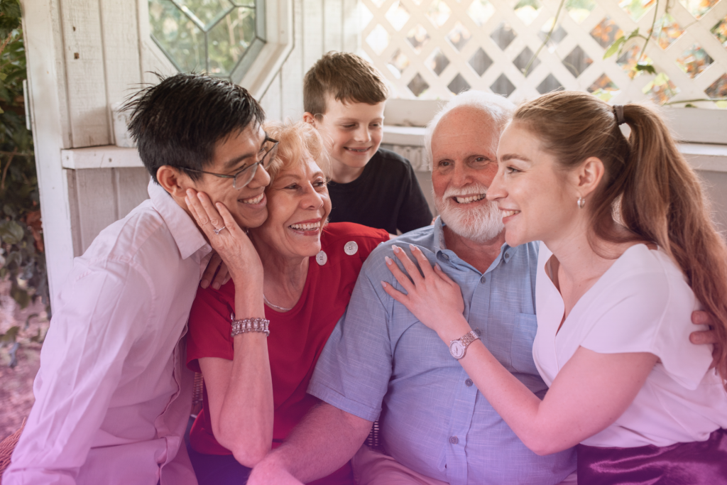 A multi-generational family gathered together, including a couple, grandparents, and their child, symbolizing the importance of inheritance planning.