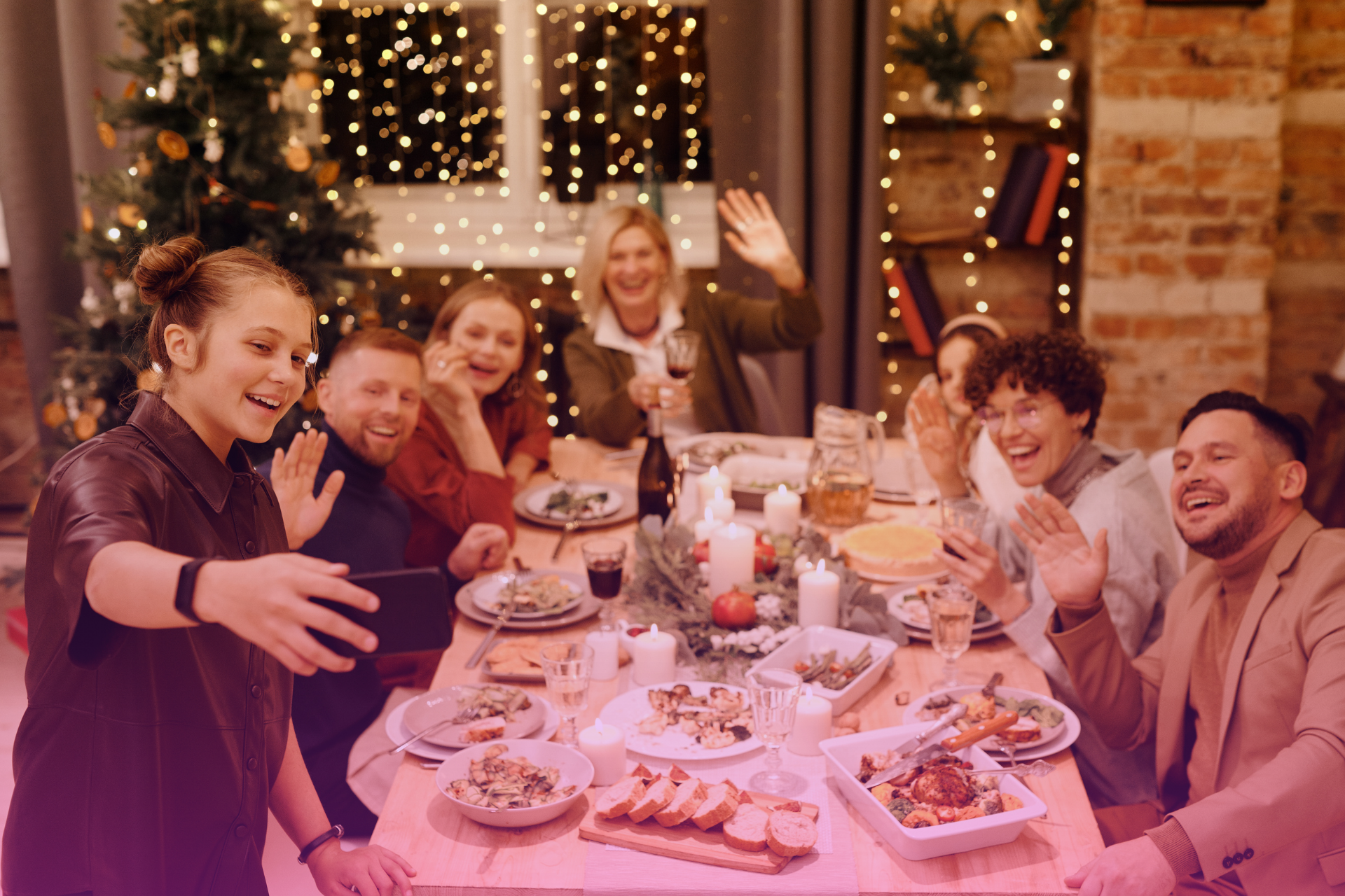 A diverse family gathered around a table, laughing and enjoying a festive holiday meal.