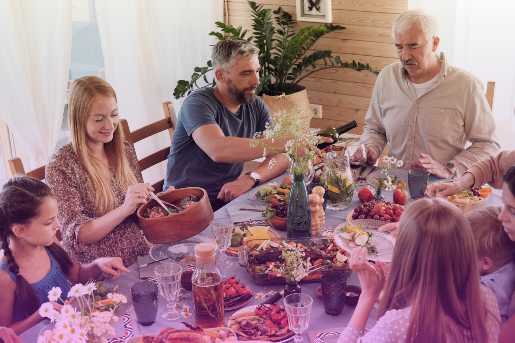 A happy family gathered around a table playing board games, enjoying a festive holiday gathering.
