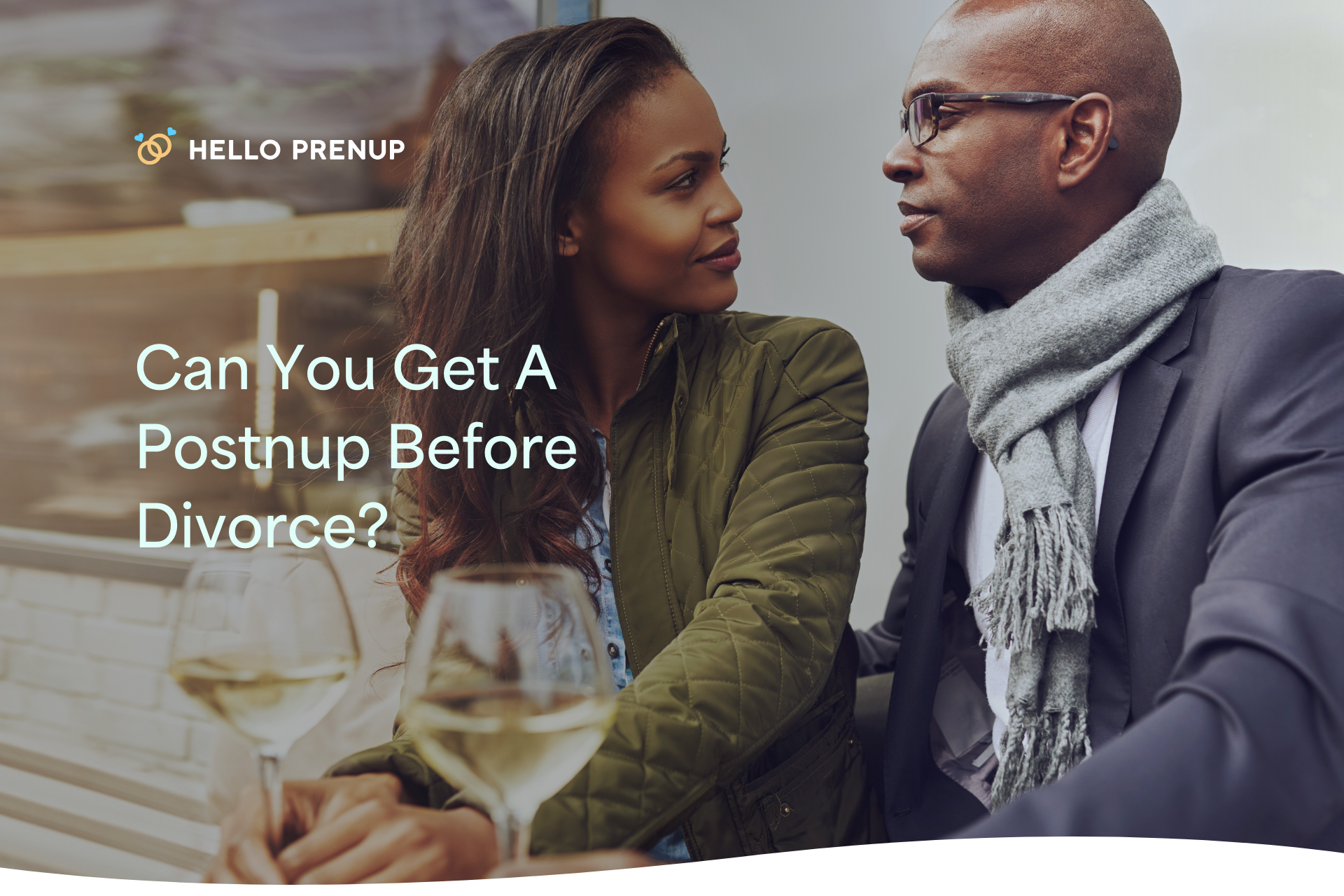 A happy couple sitting together and talking openly, with a postnuptial agreement on the table, suggesting a conversation about reconciliation.