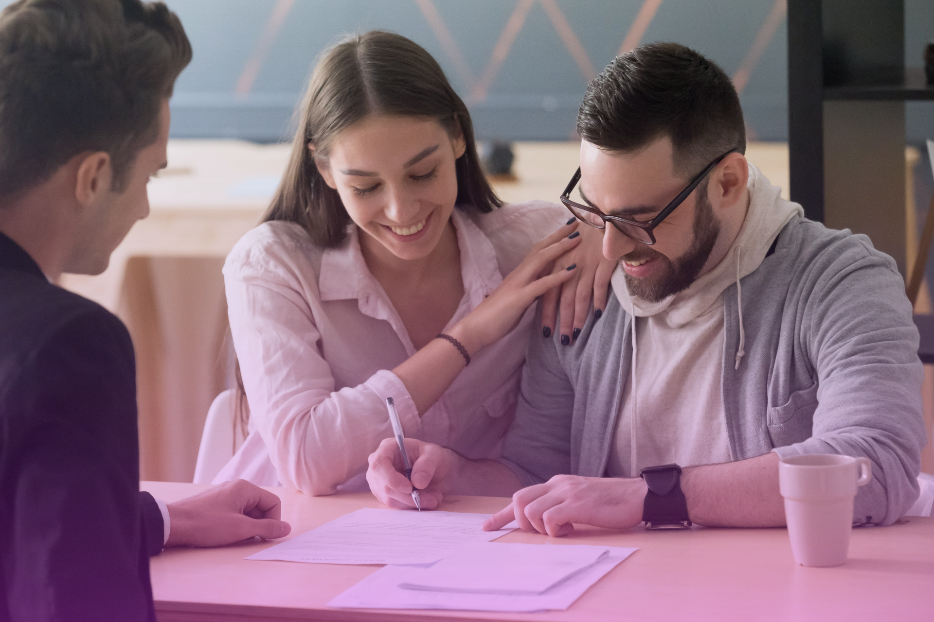 A couple signing a prenuptial agreement with a lawyer in Ontario, Canada.
