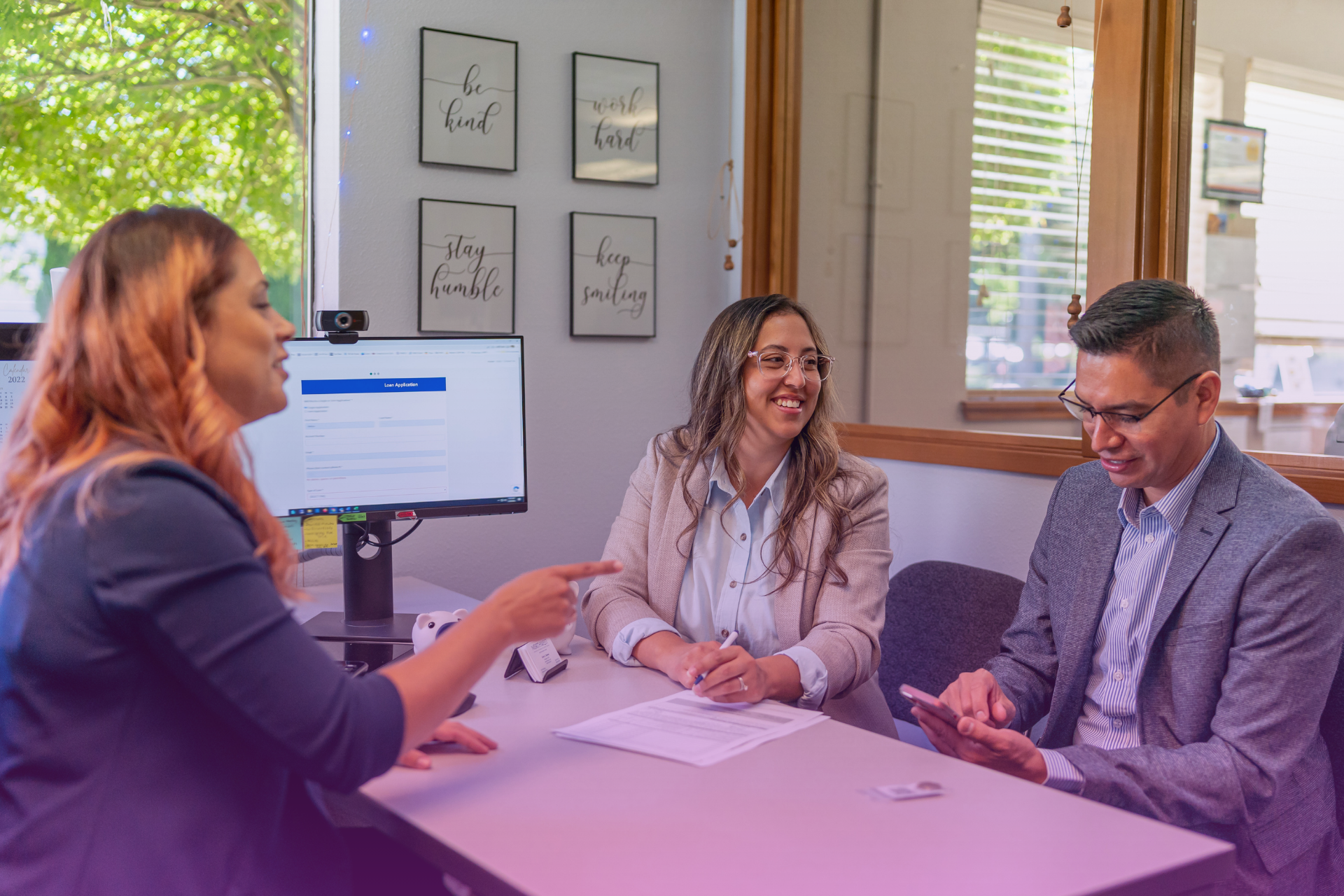 A couple sitting with a lawyer discussing legal documents", "A family discussing finances at a kitchen table