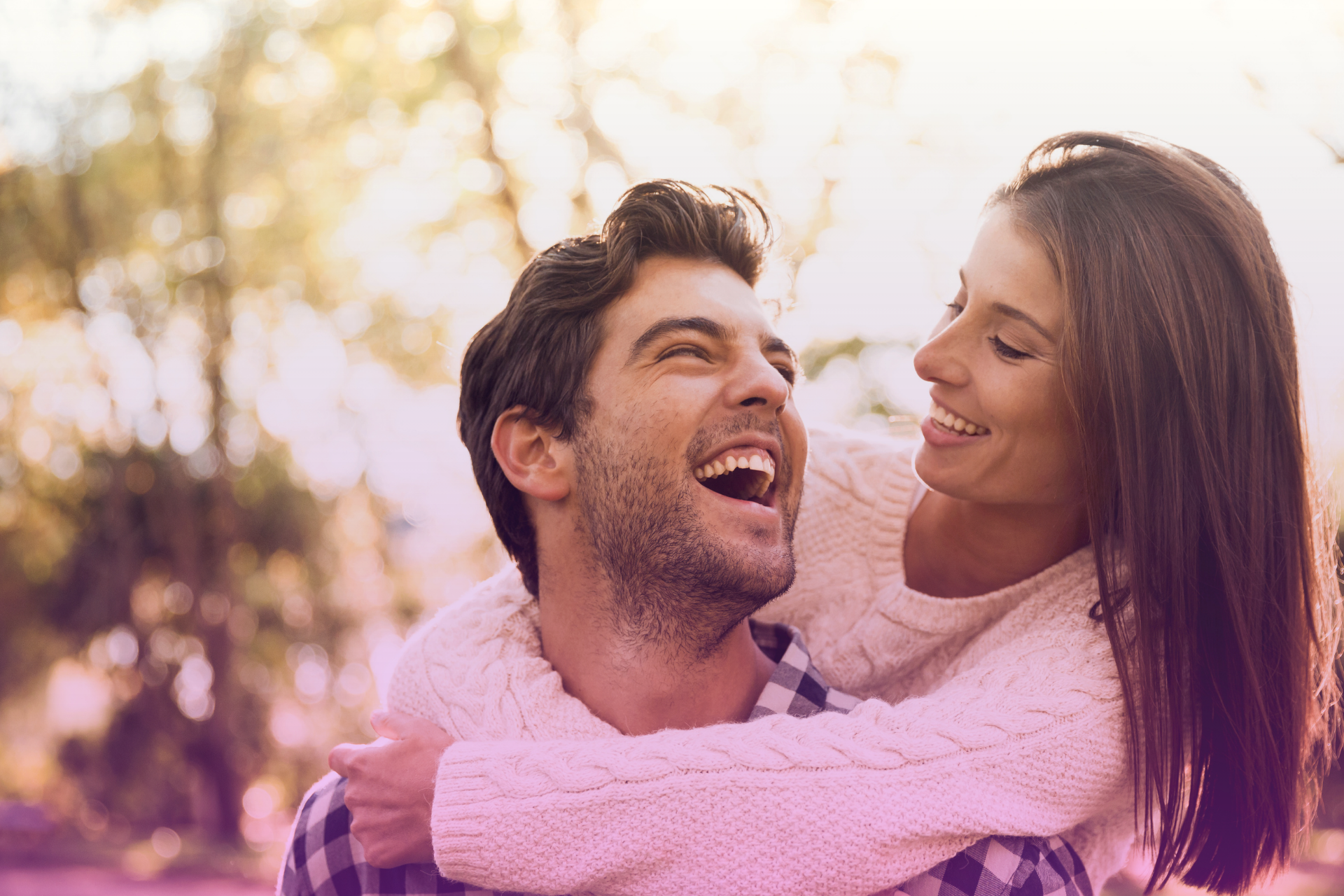 A happy couple laughing together outdoors