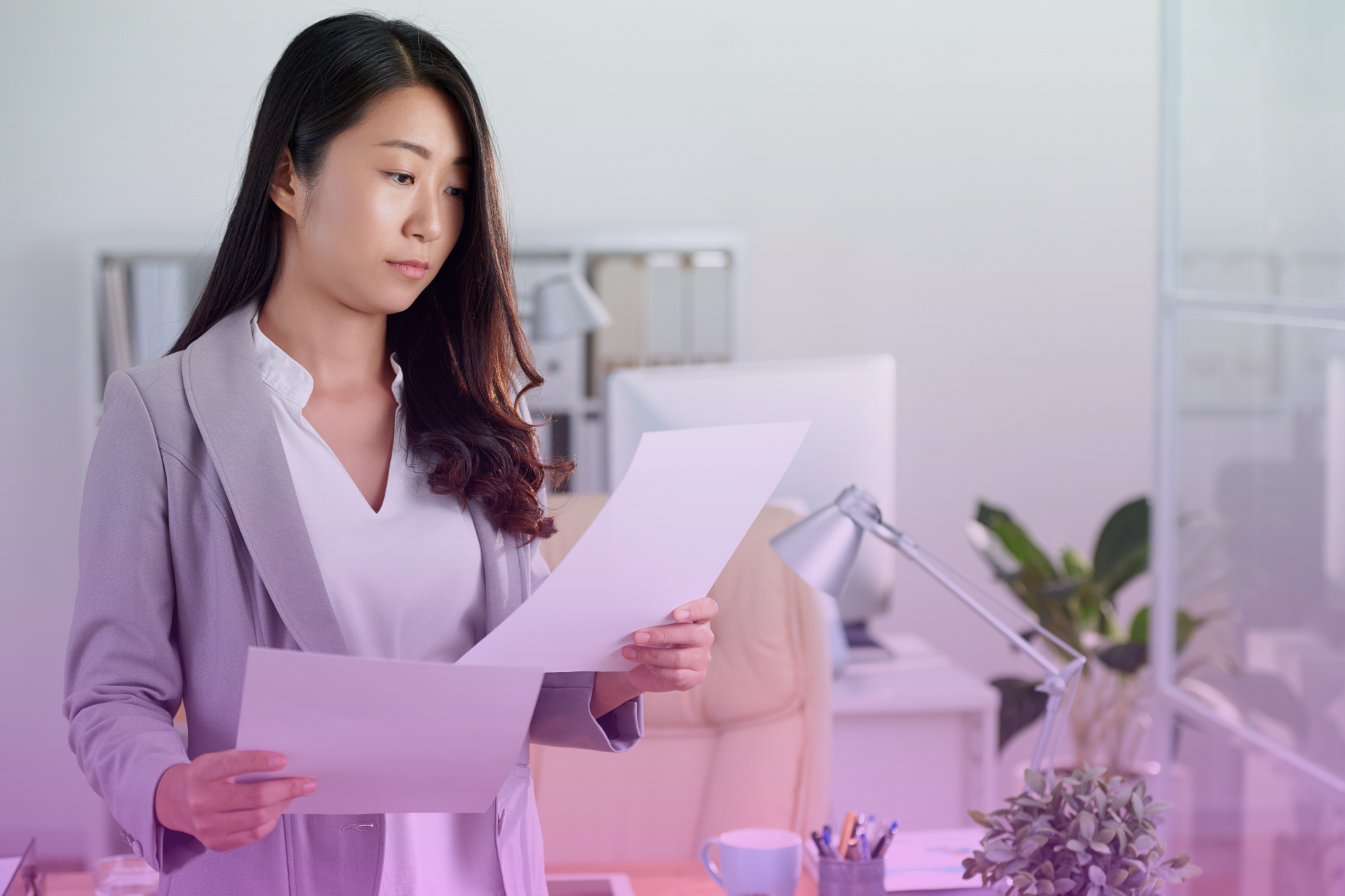A woman smiling while reviewing prenup documents without an attorney

