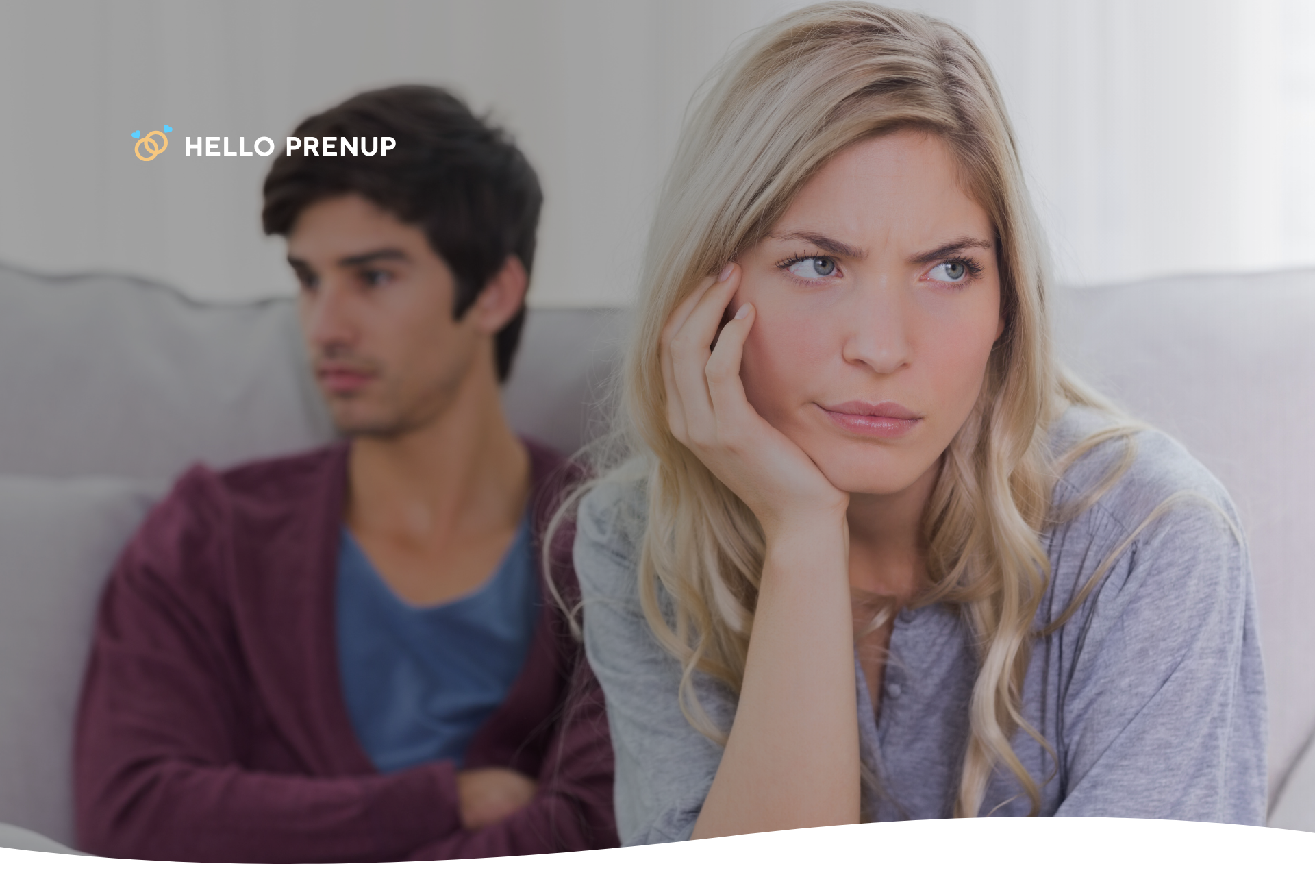 Couple sitting apart on couch, not speaking