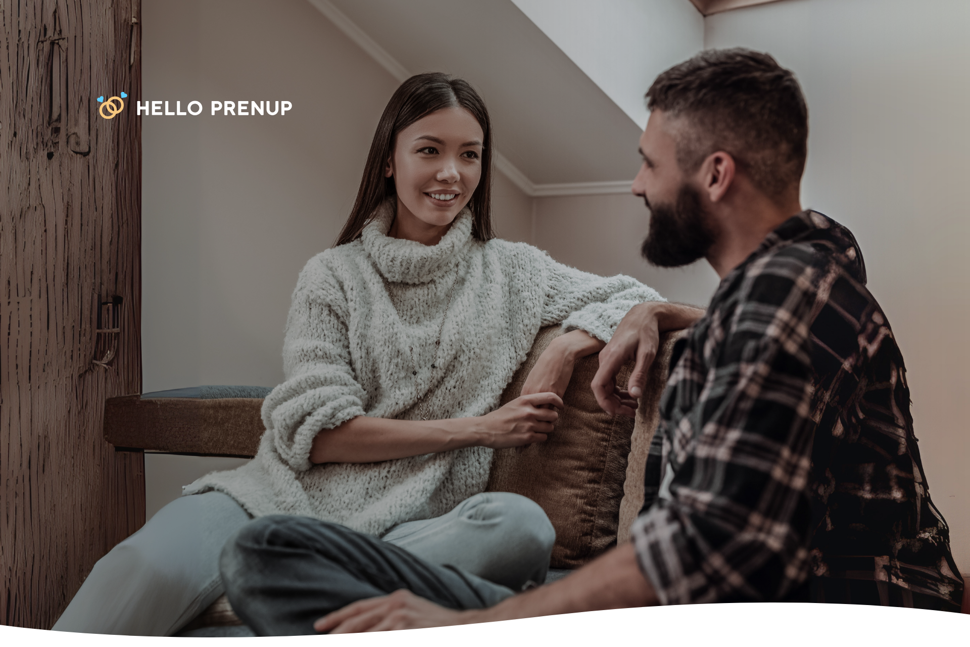 A couple engaged in a serious but calm discussion on a sofa, representing open dialogue.