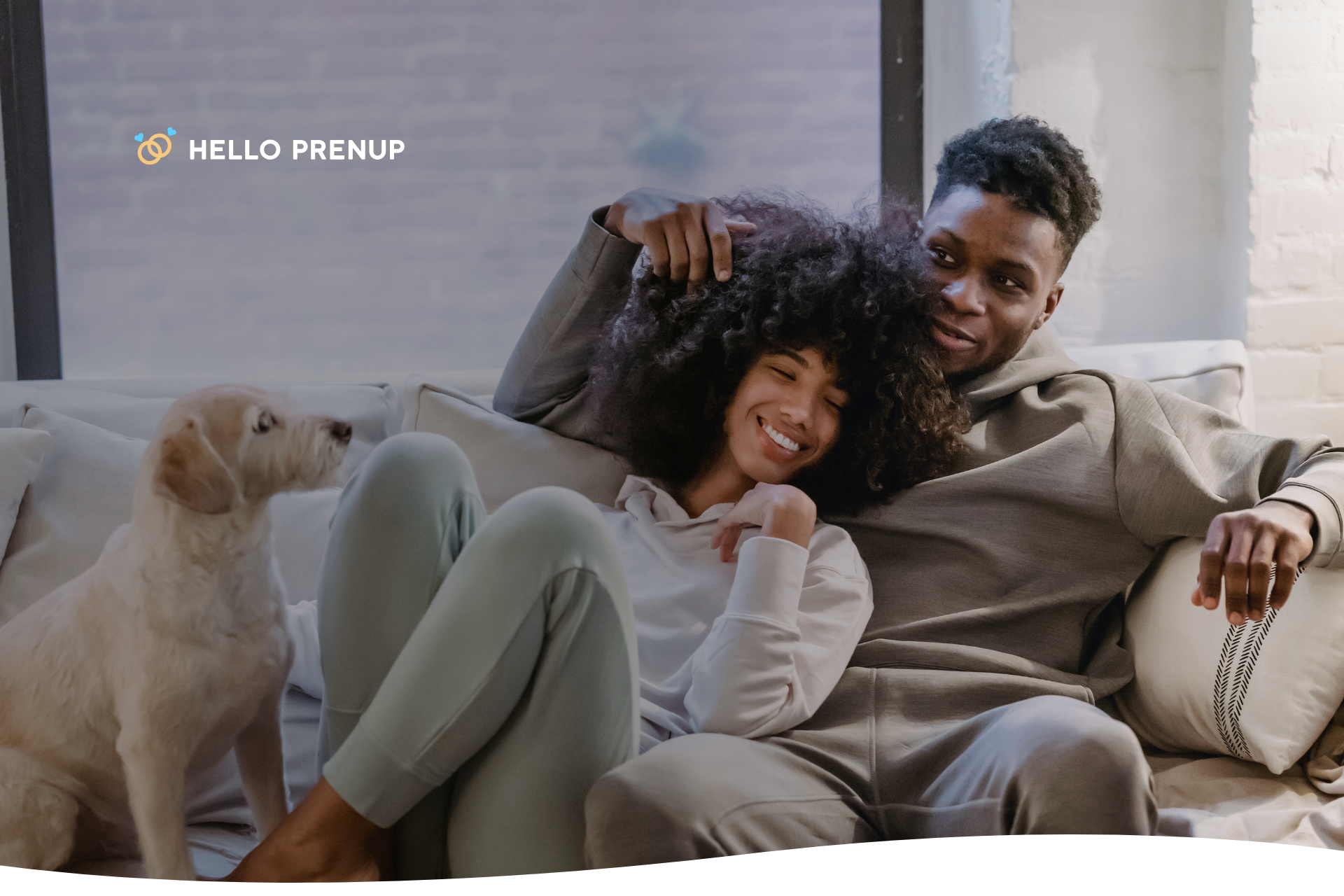 A couple gently petting their dog while sitting on a couch, illustrating a loving pet-owner relationship.