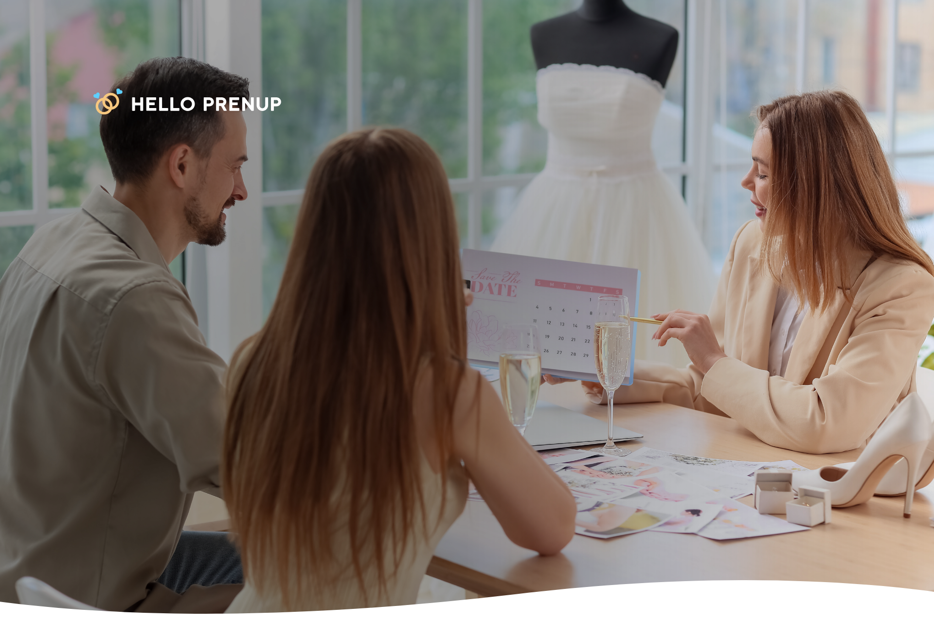 couple-planning-wedding A couple sitting at a kitchen table with laptops and wedding magazines