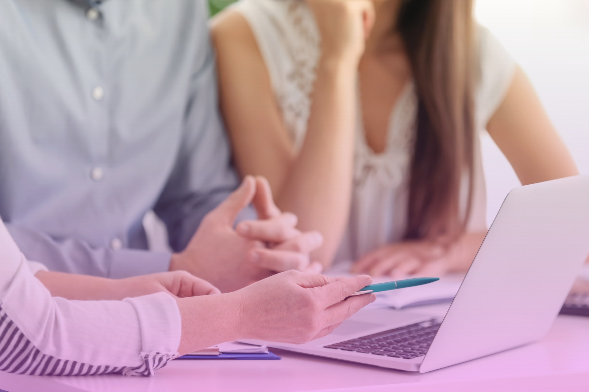 An engaged couple looking at documents together, representing their joint planning for the future.