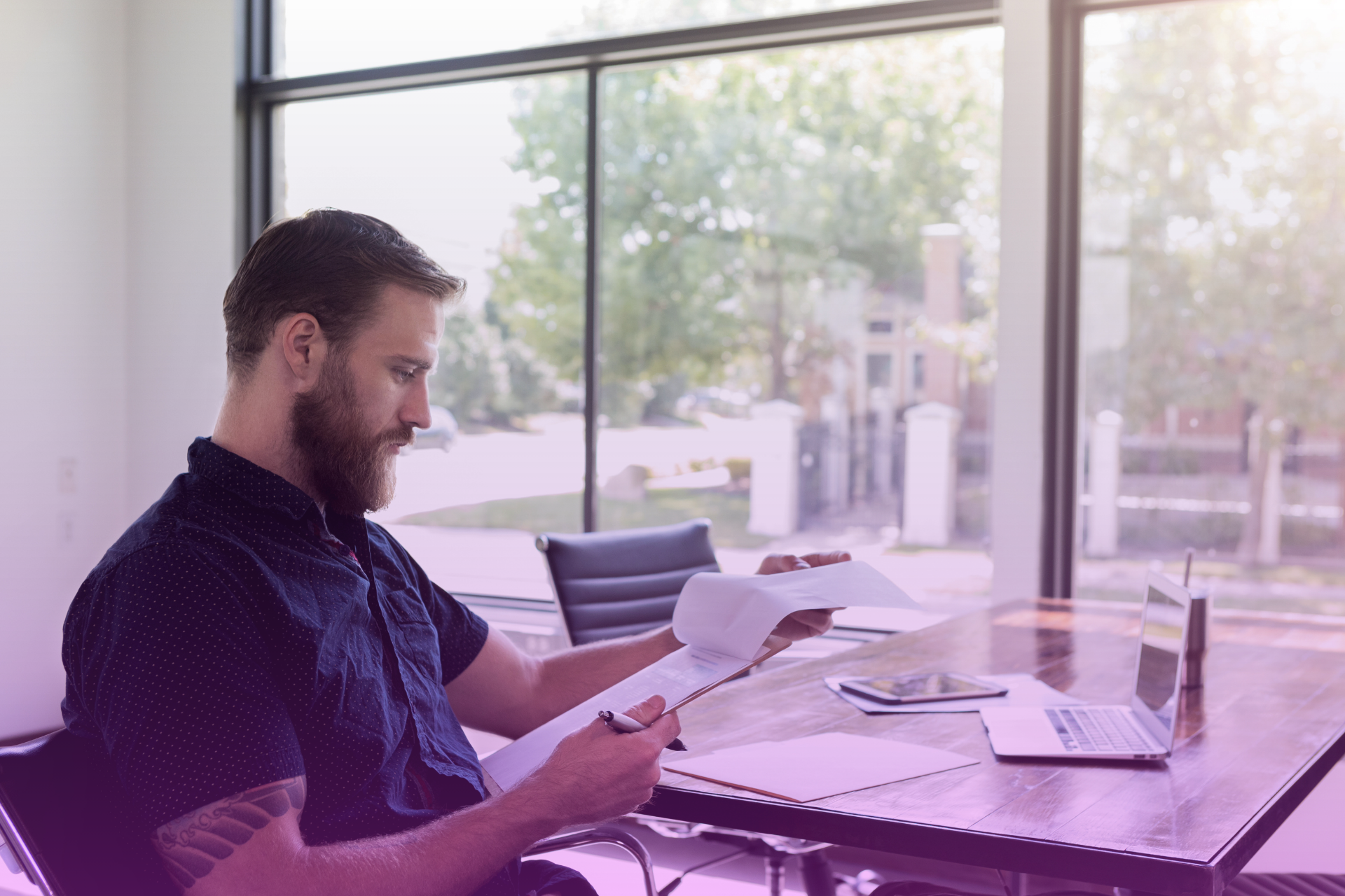 A person reviewing a document titled “Last Will & Testament” with pen in hand